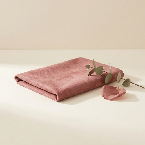 Antique-rose microfiber polishing cloth on warm ivory